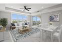 Bright living room with water views, comfy seating, and dining area at 211 Dolphin Pt # 203, Clearwater, FL 33767