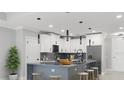 Modern kitchen with island, stainless steel appliances, and white cabinetry at 211 Dolphin Pt # 203, Clearwater, FL 33767