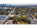 Aerial view of a vacant lot nestled among mature trees in a residential area with a clear view of the city at 705 W Amelia Ave, Tampa, FL 33602