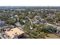 Aerial view of a residential lot surrounded by lush trees, highlighting the property's development potential at 705 W Amelia Ave, Tampa, FL 33602