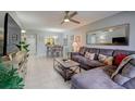 Open living area with L-shaped sofa, coffee table, and dining area at 1730 Manasota Beach Rd # 115, Englewood, FL 34223