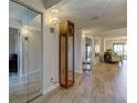 Bright and airy entryway with hardwood floors and mirrored closet at 4450 Gulf Blvd # 104, St Pete Beach, FL 33706