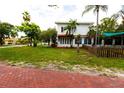Side view of the house showing the backyard and a red brick walkway at 5501 Bates St, Seminole, FL 33772