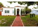 Front view of a charming two-story house with a red brick walkway and landscaping at 5501 Bates St, Seminole, FL 33772