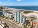 Stunning aerial perspective of the coastal condominium building, beach, and ocean at 11000 Gulf Blvd # 301, Treasure Island, FL 33706