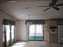 Bright dining room with a chandelier, window curtains, and access to a sunroom at 231 Tarpon Ln, Oldsmar, FL 34677