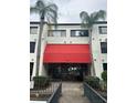 Building exterior with red awning and entrance at 2587 Countryside Blvd # 6204, Clearwater, FL 33761