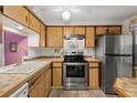 Stainless steel appliances and light wood cabinets in this kitchen at 4231 Tamargo Dr # 3, New Port Richey, FL 34652