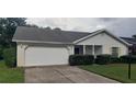 Brick ranch home with carport, well-manicured lawn, and mature shrubs at 4714 Cavendish Dr, New Port Richey, FL 34655