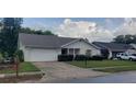 Front view of a house showing landscaping and neighborhood context at 4714 Cavendish Dr, New Port Richey, FL 34655
