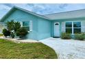 Light blue brick house with white trim and walkway at 6196 Coralberry Ter, Port Charlotte, FL 33981