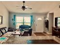 Living room with comfortable seating and access to kitchen at 6196 Coralberry Ter, Port Charlotte, FL 33981