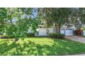 Charming single-story home with a well-manicured lawn and a two-car garage at 161 Overbrook W St, Largo, FL 33770