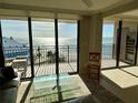 Bright living room with sliding glass doors, offering panoramic ocean views at 2618 Gulf Blvd # 505, Indian Rocks Beach, FL 33785