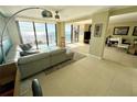 Inviting living room featuring tile floors, comfortable seating, and access to a scenic balcony at 2618 Gulf Blvd # 505, Indian Rocks Beach, FL 33785