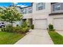 Townhouse exterior with two-car garage and landscaping at 7203 Sweet Alyssum Ct, Tampa, FL 33619