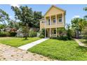 Two-story yellow house with front yard and walkway at 2430 6Th N Ave, St Petersburg, FL 33713