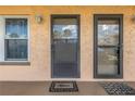 Two condo unit entrances with glass doors and welcome mats at 6400 46Th N Ave # 117, Kenneth City, FL 33709