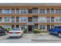 Condo building exterior with parking and entrance at 6400 46Th N Ave # 117, Kenneth City, FL 33709