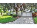 Charming mid-century home nestled on a spacious lot with mature trees at 161 Overbrook W St, Largo, FL 33770
