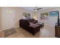 Living room with L-shaped sectional sofa and large TV at 5733 66Th N Ln, St Petersburg, FL 33709