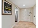 Hallway with light walls, wood-look floors, and white door at 36750 Us Highway 19 N # 15305, Palm Harbor, FL 34684