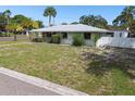 House with a large front yard and a white fence at 7979 Garden N Dr, St Petersburg, FL 33710