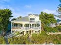 Front view of beach house with wrap around porch at 20052 Gulf Blvd, Indian Shores, FL 33785