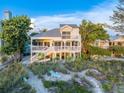 Beachfront property featuring a charming two-story home at 20052 Gulf Blvd, Indian Shores, FL 33785