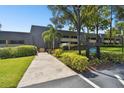 Saint Andrews Lodge 23 building exterior with landscaped grounds at 36750 Us Highway 19 # 23-110, Palm Harbor, FL 34684