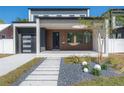 Contemporary home with walkway, landscaping, and attached garage at 2721 17Th N Ave, St Petersburg, FL 33713