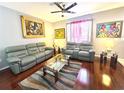 Inviting living room featuring hardwood floors, plush seating, and ample natural light at 6546 Marlberry Way, Largo, FL 33773