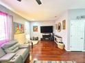 Spacious living room showcasing stylish decor, hardwood floors, and a modern entertainment setup at 6546 Marlberry Way, Largo, FL 33773