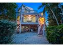 Charming two-story pink house with elevated deck and stairs at 20051 Gulf Blvd, Indian Shores, FL 33785