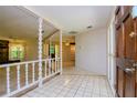Bright entryway with tiled floors and white balustrade at 15350 Scanio Dr, Spring Hill, FL 34610