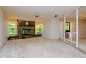 Spacious living room featuring a stone fireplace and high ceilings at 15350 Scanio Dr, Spring Hill, FL 34610
