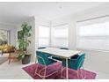 Bright dining area with a marble-top table and four teal velvet chairs at 2400 Feather Sound Dr # 1318, Clearwater, FL 33762