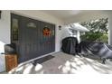 Double front doors, welcome mat, and fall decorations at 10208 Grove Dr, Port Richey, FL 34668