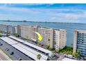 Aerial view of a high rise building with parking and water views at 5980 Shore S Blvd # 209, Gulfport, FL 33707