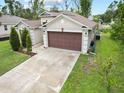 Single story house with brown garage door and driveway at 2193 Peake St, North Port, FL 34286
