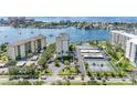 Aerial view of waterfront community, featuring tennis courts, pool, and boat slips at 660 Island Way # 401, Clearwater, FL 33767