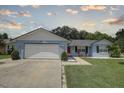 One-story home with attached garage and lawn at 4541 Whitetail Ln, New Port Richey, FL 34653