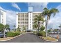 High rise building exterior with ample parking and landscaping at 9415 Blind Pass Rd # 803, St Pete Beach, FL 33706