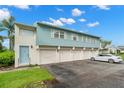 Condo building with multiple garages and a car parked in front at 3247 38Th S Way # C, St Petersburg, FL 33711