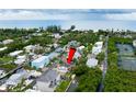 Aerial view showing home's location near the water and other houses at 651 Jungle Queen Way, Longboat Key, FL 34228