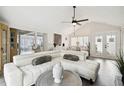Spacious living room with white sectional sofa, coffee table, and vaulted ceiling at 7518 Clanton Trl, Hudson, FL 34667