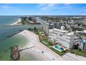 Breathtaking aerial view of a beachfront condominium complex, pool, beach, and surrounding waterways at 7000 Beach Plz # 505, St Pete Beach, FL 33706