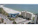 Breathtaking aerial view showcasing the condominium, sandy beach, and picturesque ocean views at 7000 Beach Plz # 505, St Pete Beach, FL 33706