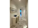 Bright hallway with marble floors, modern decor, and a glimpse of the outside at 777 3Rd N Ave # 908, St Petersburg, FL 33701