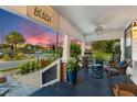 Relaxing front porch with seating and lovely sunset view at 489 Wood St, Dunedin, FL 34698